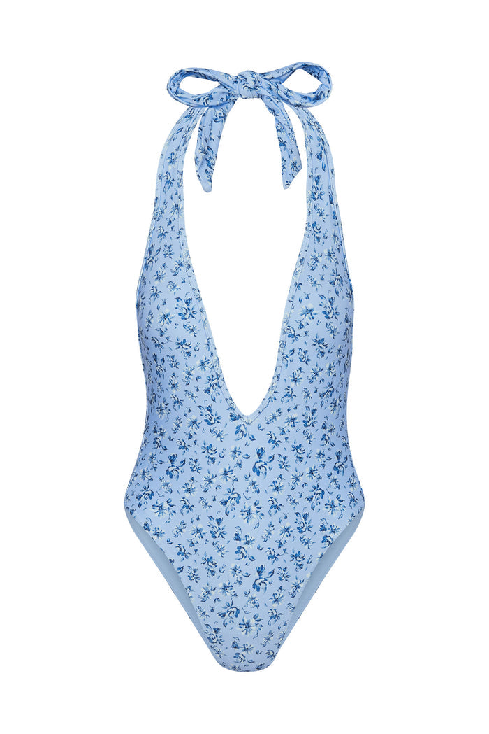 Front view of Cyprus one-piece Isola Floral with deep halter plunge, high-cut legs, and light blue floral print on white