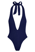 Front of Cyprus One Piece in Midnight Crinkle, halter plunge V-neck with tie and textured fabric, high-leg cheeky cut on white
