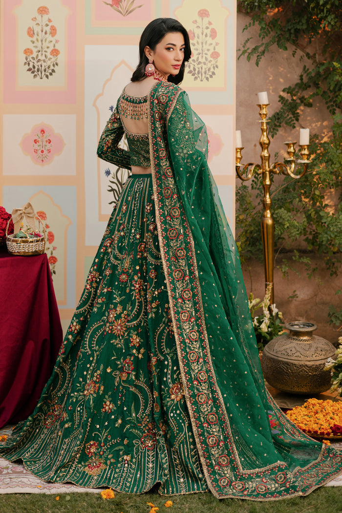Back view of NAQSHI Danir choli displaying heavily bejeweled bodice and hanging handmade tassels at back slit adding festive flair.