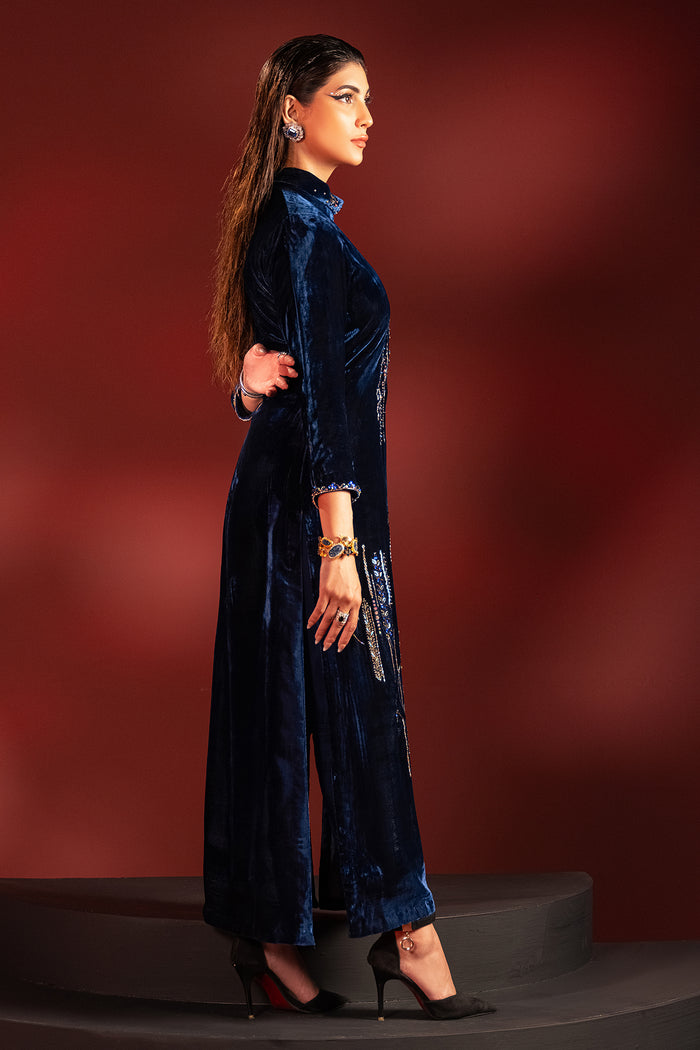 Side view of neon blue velvet long shirt and straight trousers showing clean fall and fitted sleeves, elegant ready made formal party outfit.