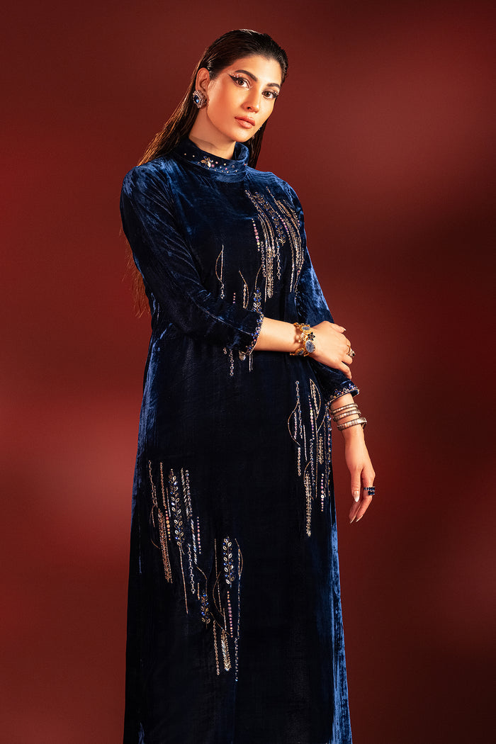 Three quarter pose of neon blue velvet outfit showing sleeve detailing and balanced straight cut, formal ready made dinner wear.