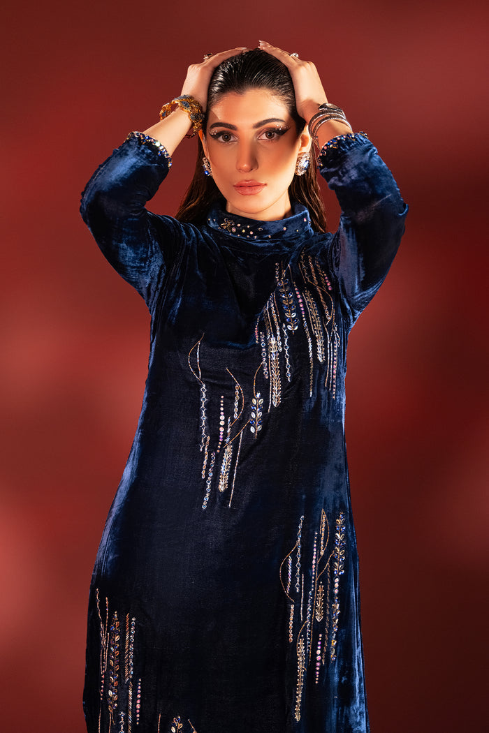 Front portrait of neon blue velvet dress focusing on ban neckline embellishment and stone work, elegant ready to wear formal attire.