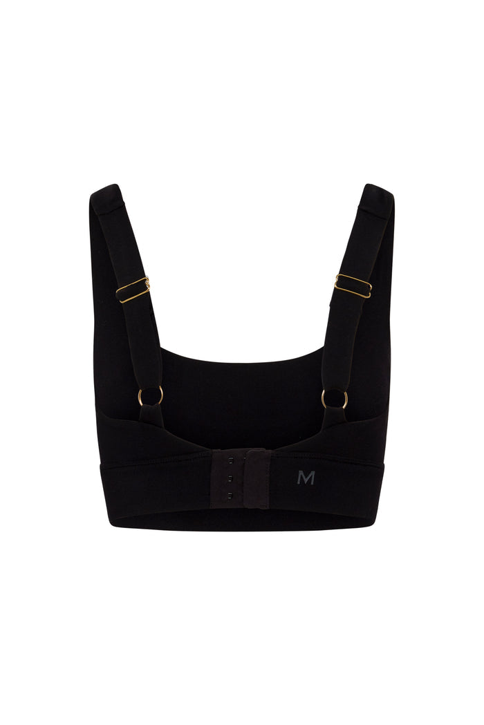 Back view of Devin Bra in black showing adjustable straps, gold hardware, hook-and-eye closure, and printed M size mark on white background