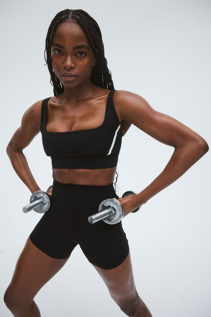 Front view of The Devin Bra in Black/Ivory showing square neckline and wide straps on model against a light grey background