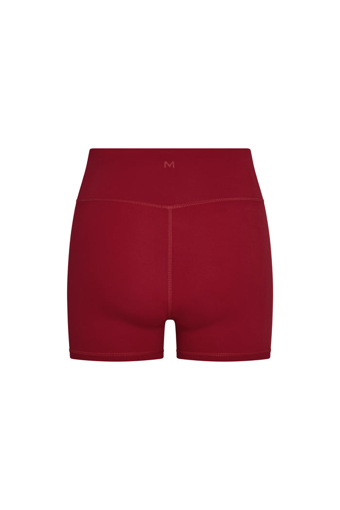 Back view of Elysian Short in cherry showing high-rise waistband, center back seam and short inseam on white background