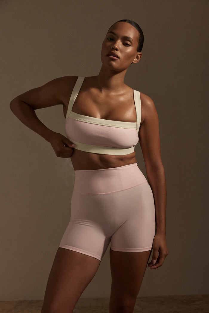 Front view of Elysian Short in Heather Powder Pink showing high waist with doubled waistband and 4.5 inch inseam on model