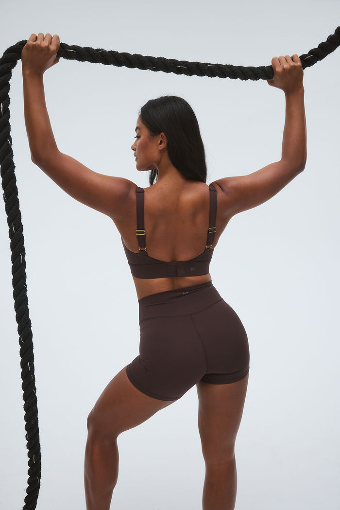 Rear view of Elysian Short 4.5 inch in Espresso on model, showing high-waist fit and short inseam against light gray background