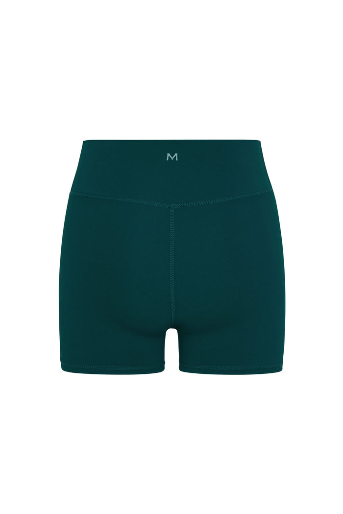 High-waist teal athletic bike shorts with small M logo centered on waistband