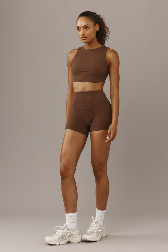 Front view of Elysian Short 4.5-inch Cliffside ribbed high-waist shorts on model against neutral gray background