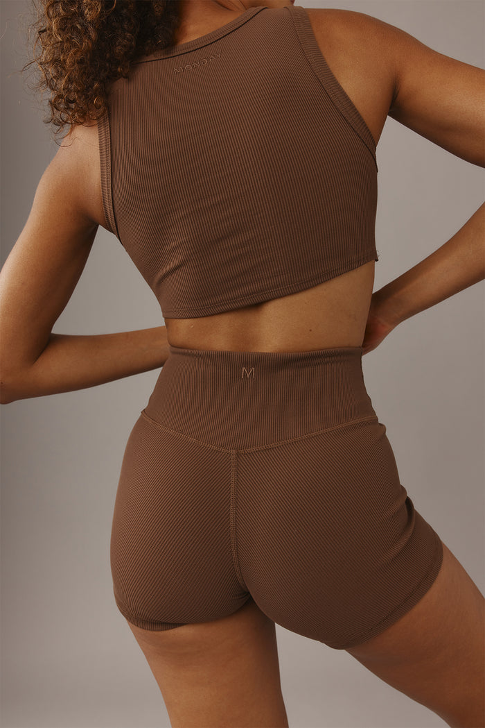 Rear view of Elysian Short 4.5in in Cliffside rib showing high-rise waistband, ribbed fabric, back seam and small M logo