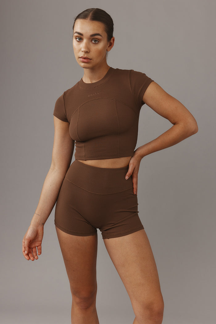 Front of Elysian Short 4.5-inch Cliffside rib showing high-rise waistband and fitted ribbed fabric on gray background