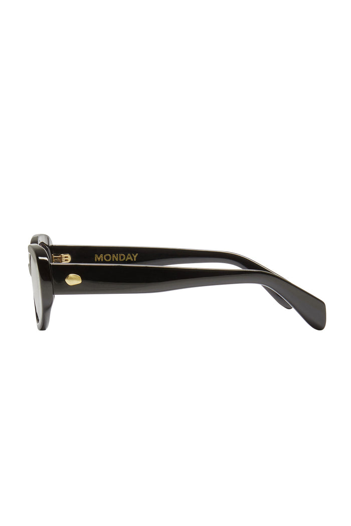 Black acetate sunglasses, side view showing gold MONDAY text on the temple and a small gold rivet