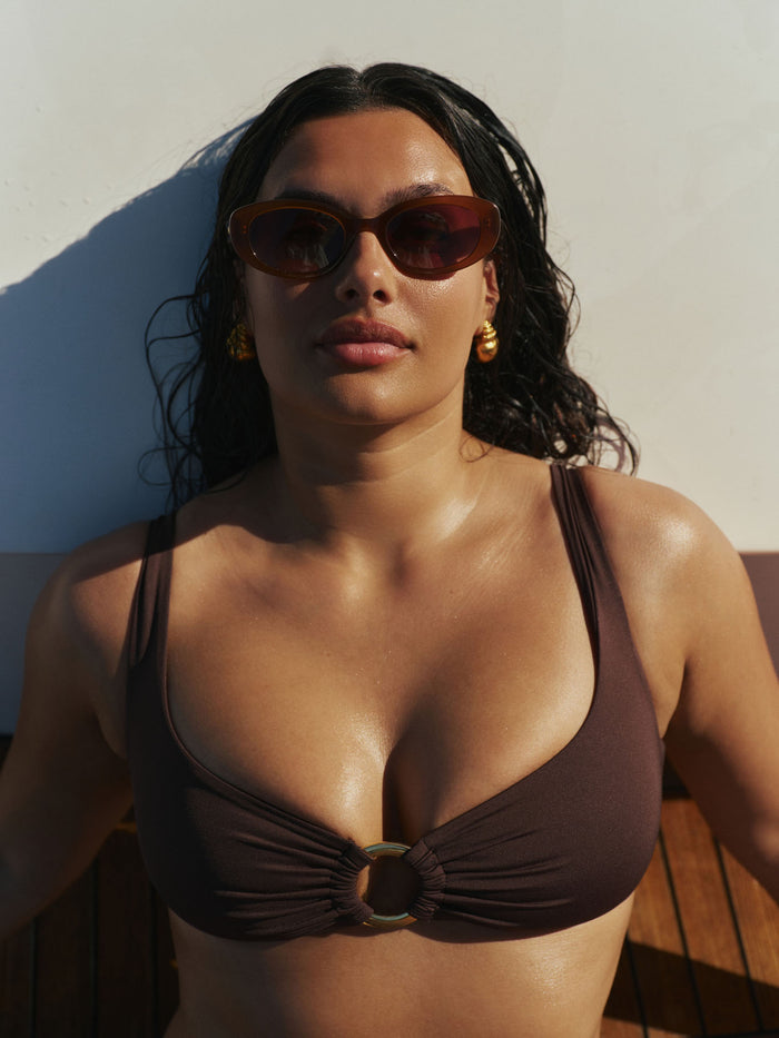 Close-up of Es Vedrá sunglasses in brown on a model, showing brown gradient lenses and translucent tortoiseshell frame