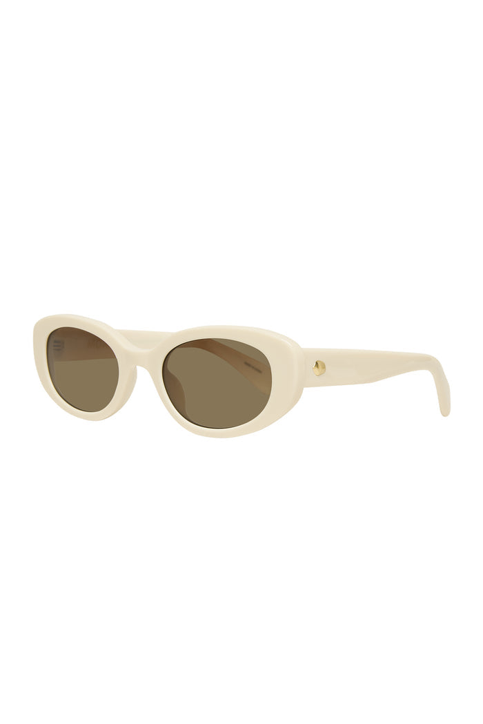 Cream cat-eye sunglasses with brown lenses and glossy acetate frame on white background