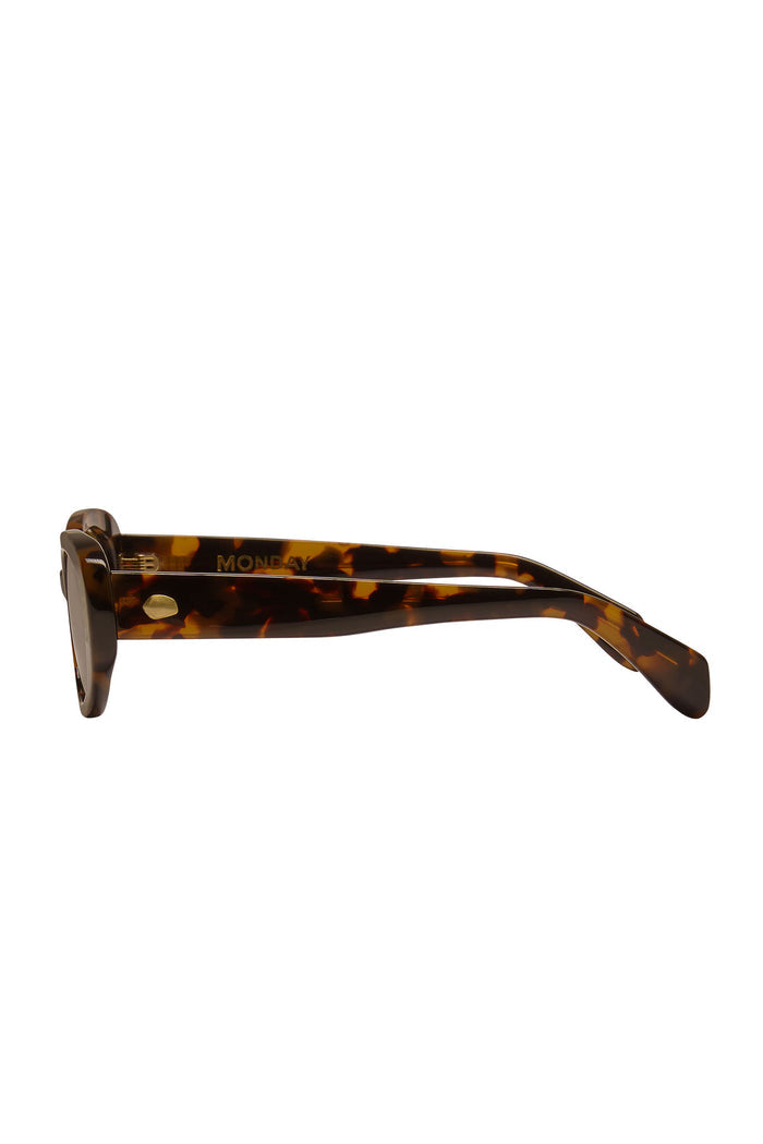 Tortoiseshell sunglasses side view showing gold MONDAY logo on the acetate temple