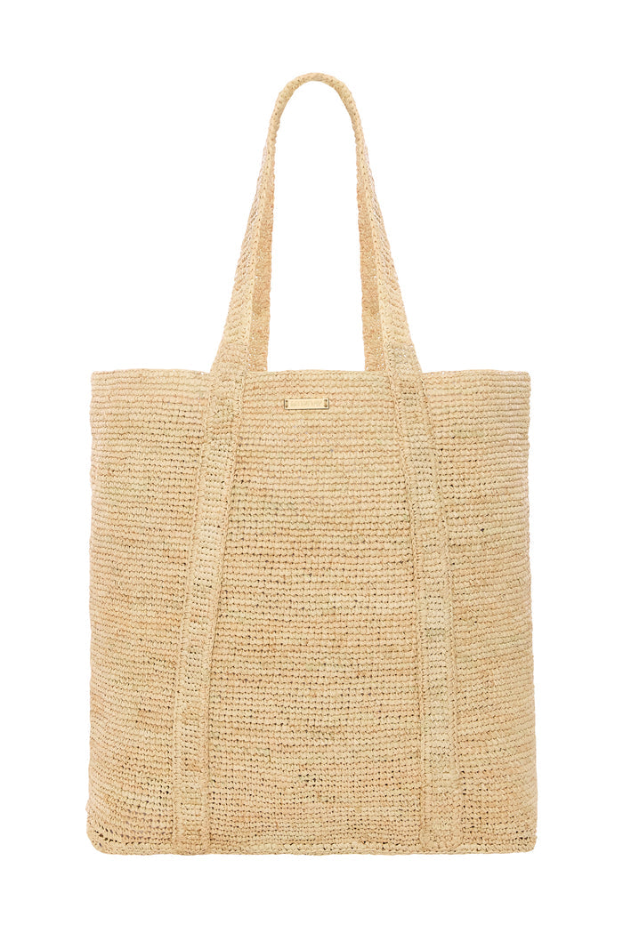 Front view of Exuma Bag in natural raffia showing hand crocheted texture, long shoulder straps, rectangular tote on white background