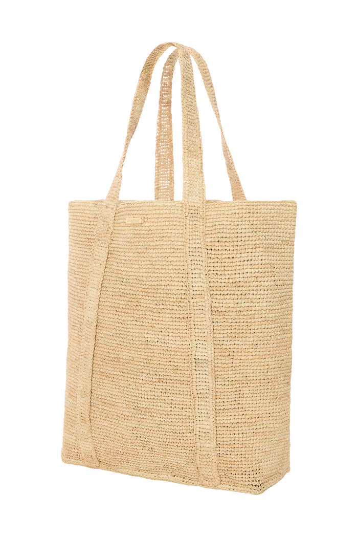 Front view of Exuma Bag in natural raffia showing woven crochet texture and long double shoulder straps on white background