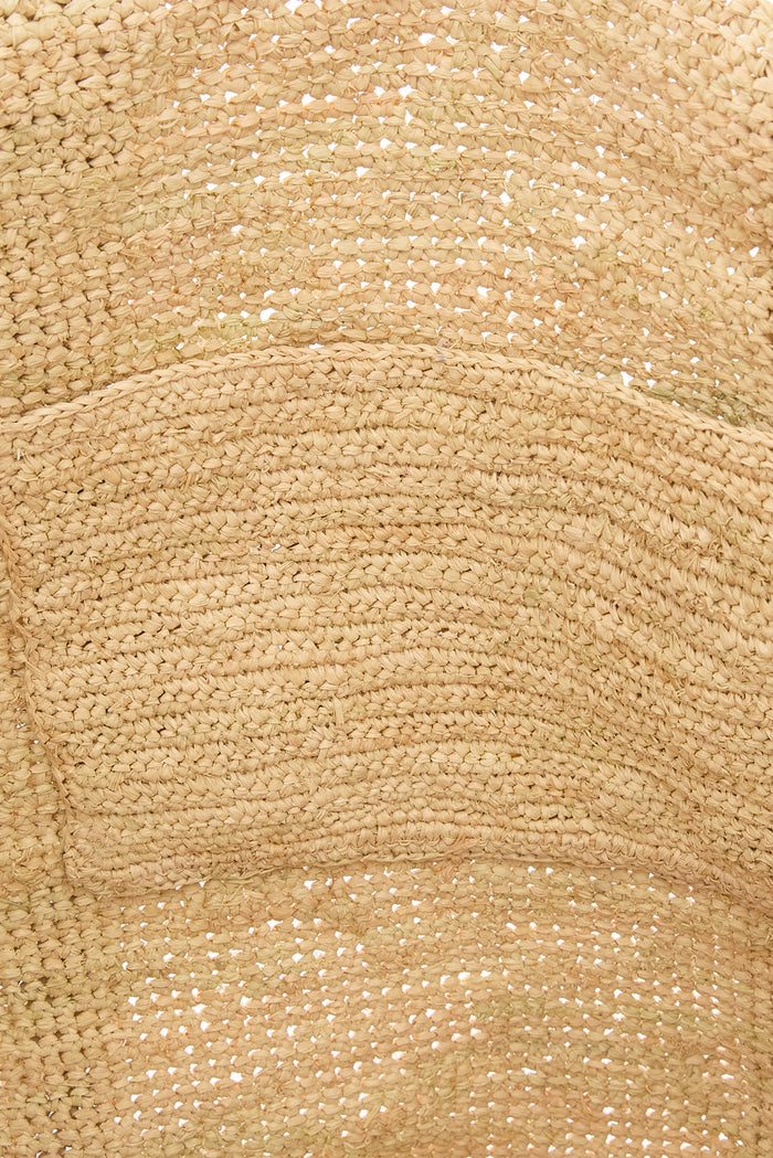 Close-up of Exuma Bag Natural showcasing hand-crocheted raffia texture with visible cotton lining
