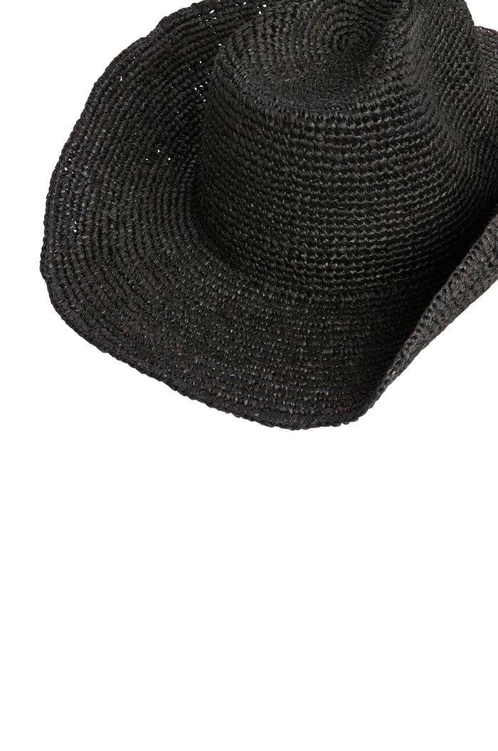 Angled top view of Exuma Raffia Hat in black showing woven raffia texture and wide brim on white background