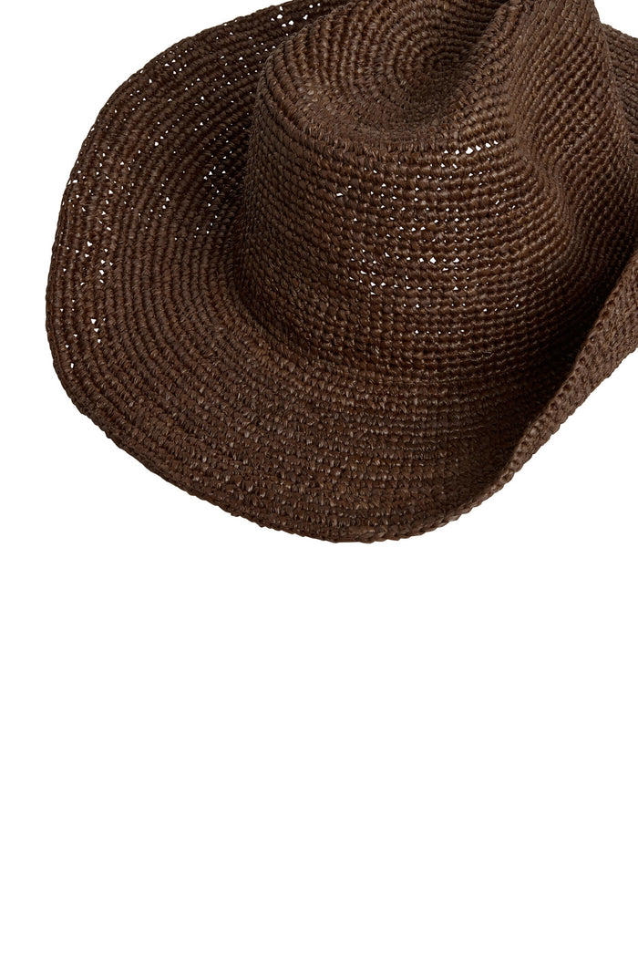 Angled close-up of Exuma Raffia Hat in espresso showcasing braided raffia weave and wide floppy brim on white background