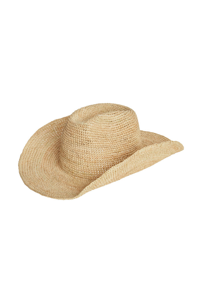 Three-quarter front view of Exuma raffia hat showing woven straw texture and wide curved brim on white background