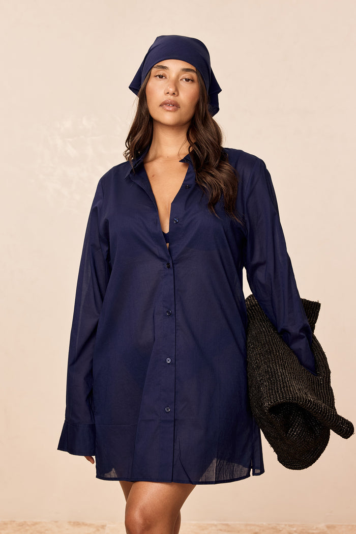 Front view of Fiji Tunic in Midnight Cotton Voile, semi-sheer button-front tunic with side pockets on a light background