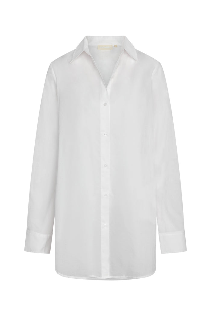 Front view of Fiji Tunic in white showing semi sheer cotton voile, button front closure and tunic length with side slits on white background