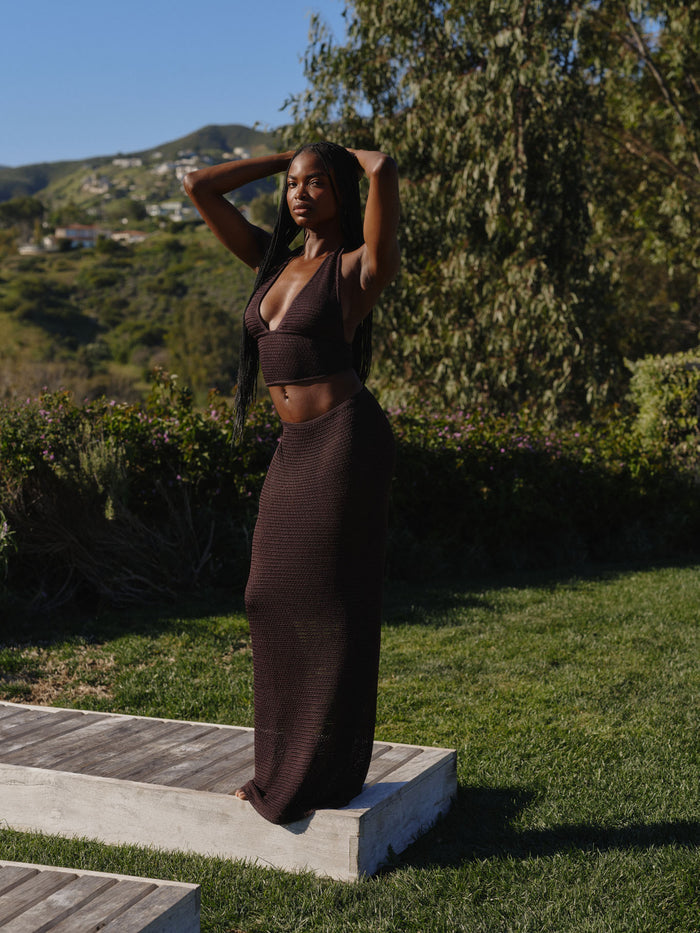 Front view of Fontelina Skirt in Espresso Treble Knit, fitted high-waist maxi with textured knit, outdoor hillside background