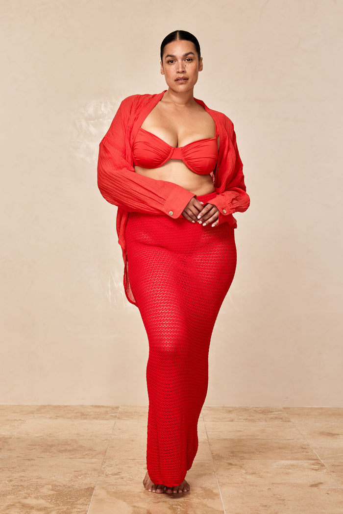 Front view of Fontelina Skirt in Chili Pepper lace crochet, long form-fitting semi-sheer skirt on model against neutral floor
