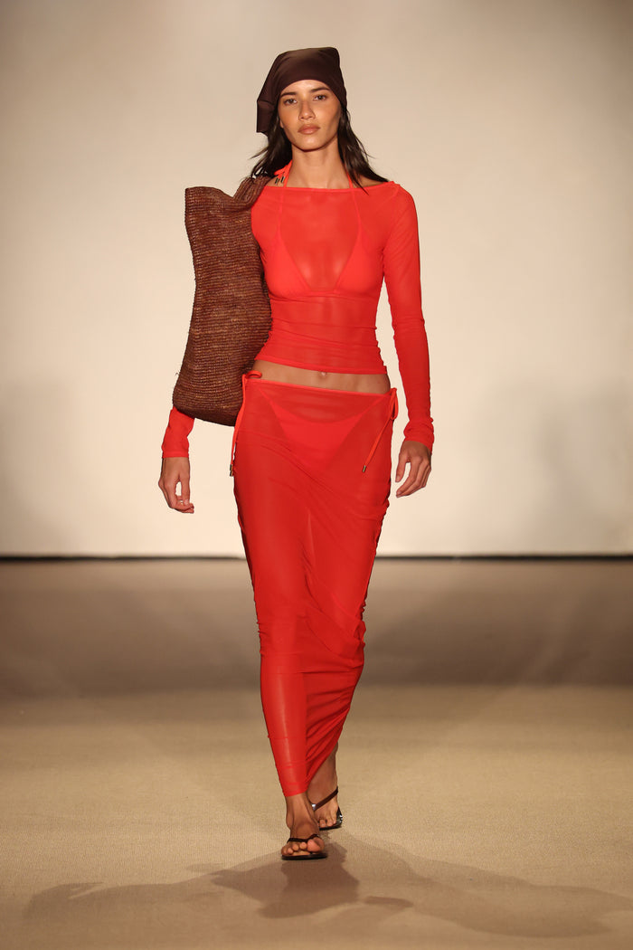 Front view of Ipanema Top in chili pepper mesh showcasing sheer long sleeves and layered bikini top on runway