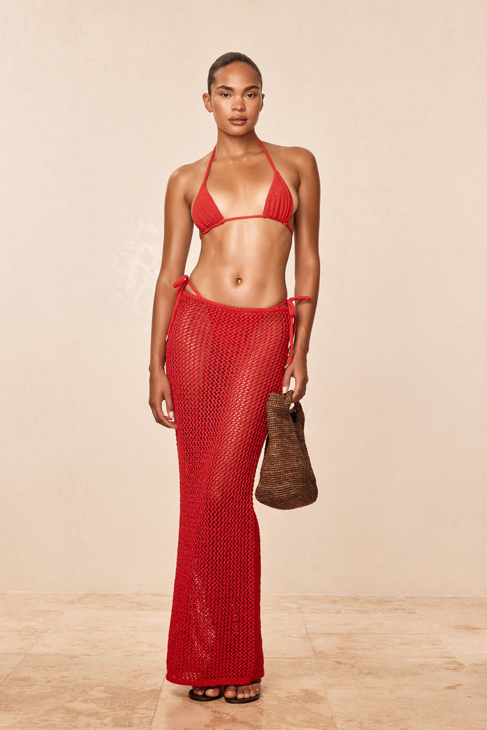 Front view of Fontelina skirt in Chili Pepper crochet, long tie-side open-knit design on model, neutral background