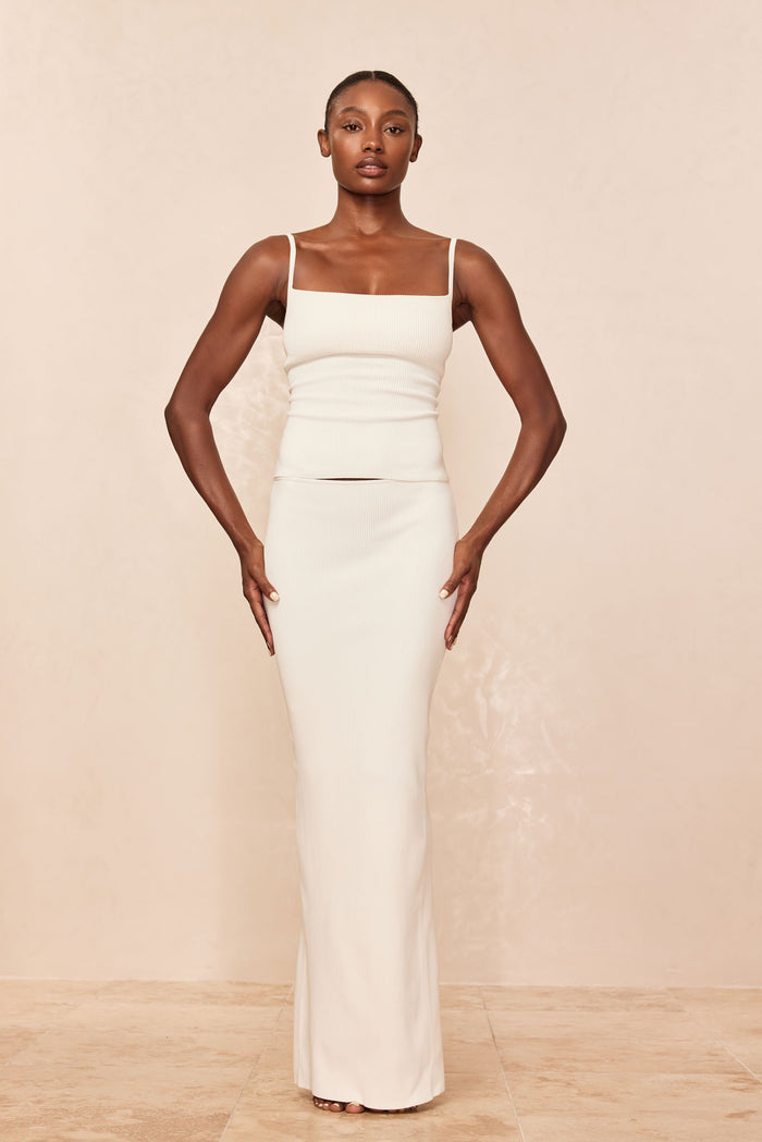 Front view of Fontelina skirt in ivory knit showcasing fitted column silhouette and slight hem flare on neutral background