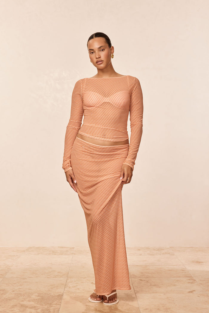 Front view of Fontelina Skirt - Micro Geo Mesh showcasing orange geometric mesh and high-waist straight-cut maxi on model against beige background