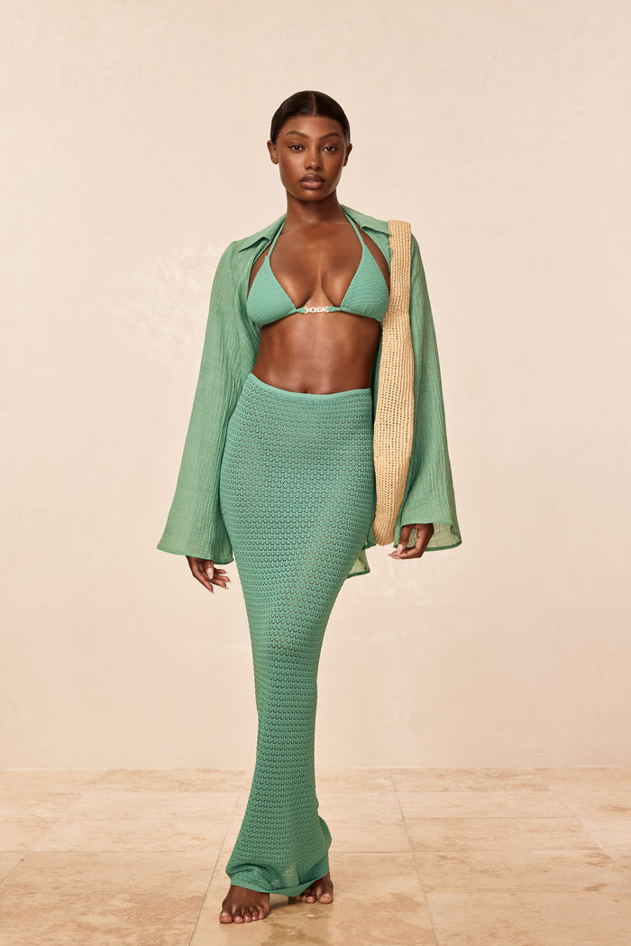 Front view of Fontelina Skirt in Pond Lace Crochet in green showing high-waisted fitted mermaid silhouette on model with beige background