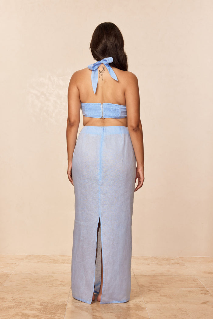 Back view of Fontelina Skirt in Sky Linen showcasing high-waist maxi length and center back slit with neutral studio background