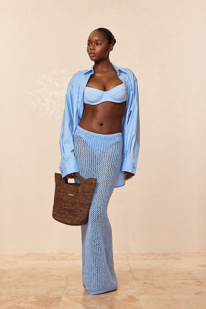 Front view of Fontelina Skirt in Sky Petit Crochet showcasing open crochet knit and fitted hip-to-ankle silhouette on model against beige background