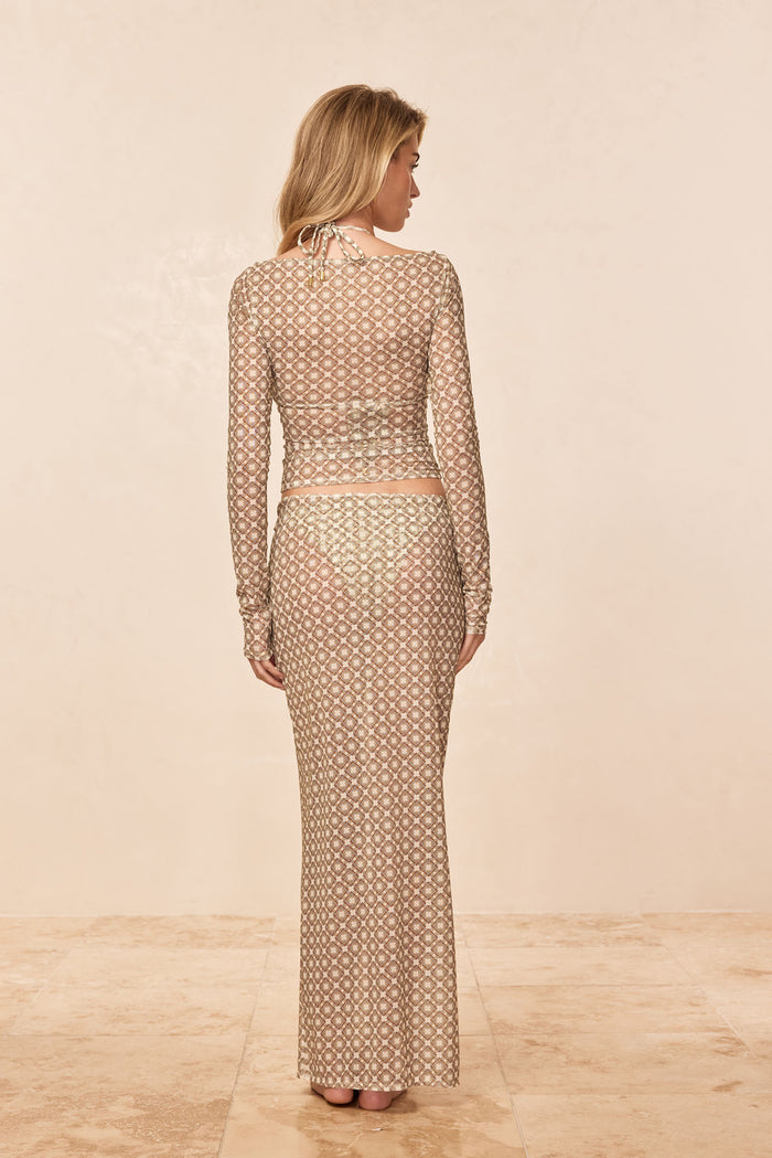 Back view of Fontelina Skirt Tile Geo Mesh showcasing semi-sheer geometric mesh and slim fit on model with neutral background