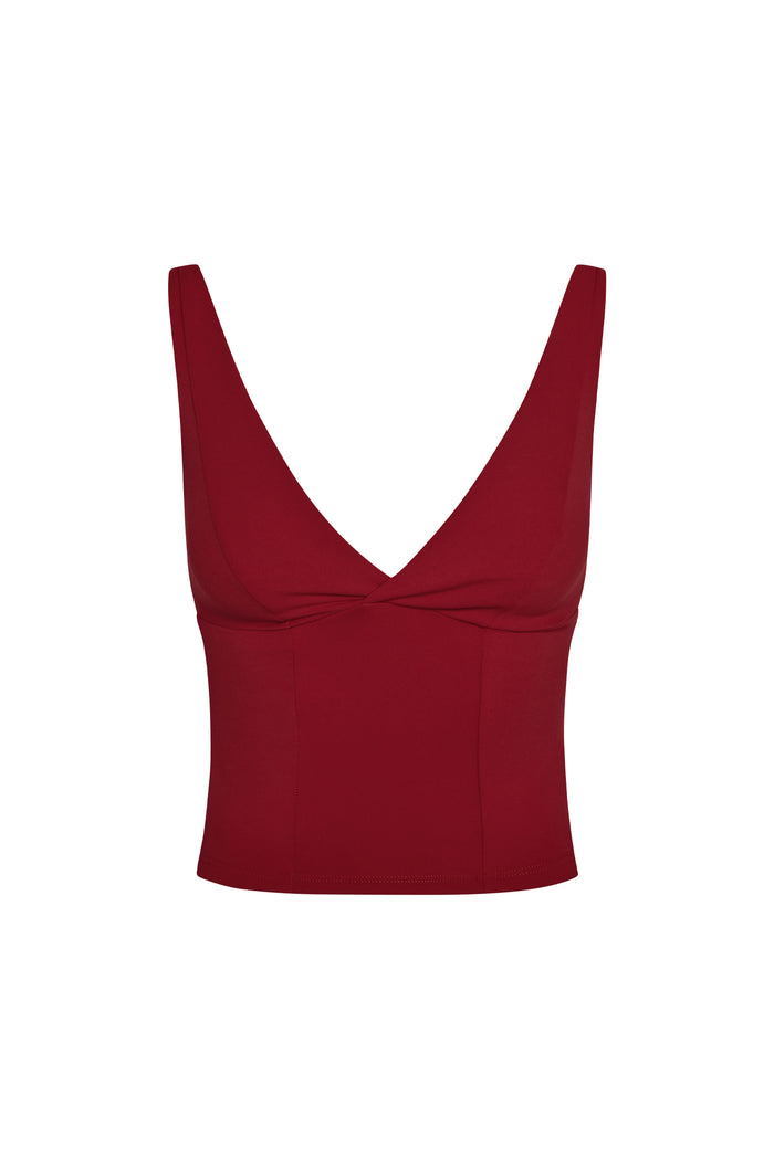 Front view of Glacier Tank in cherry showing deep V-neck, twisted front seam and adjustable over-the-shoulder straps on white background