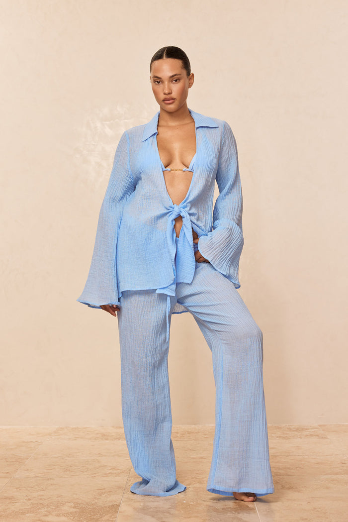 Front view of Grenada Tunic in Sky Crinkle linen with tie-front, long flared sleeves, and matching wide-leg pants on a neutral background