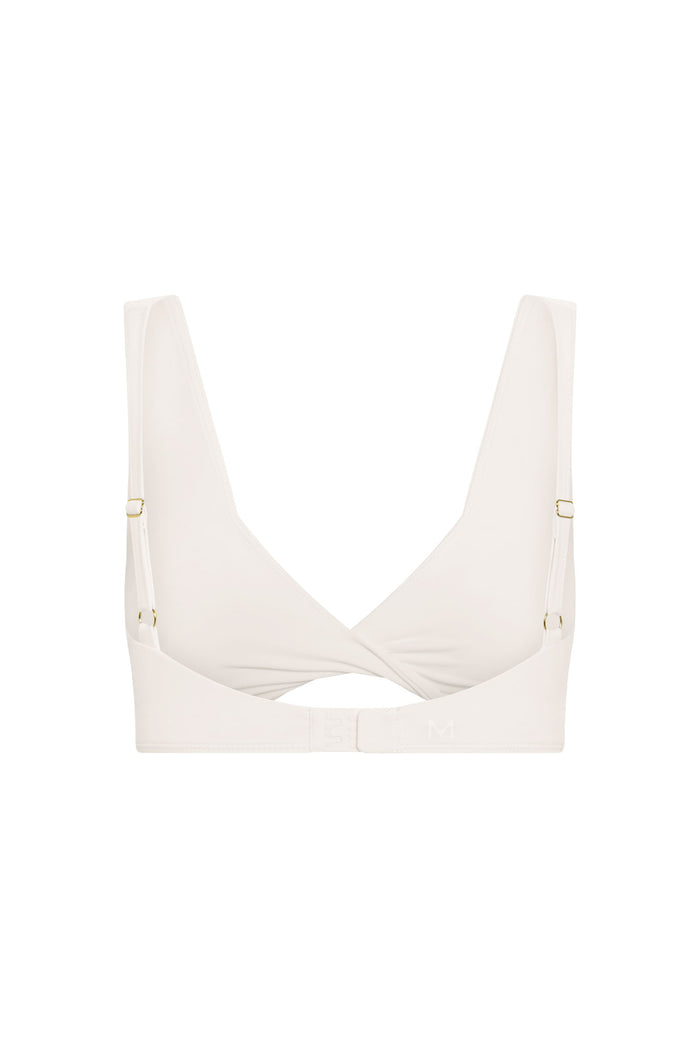 Ivory soft-cup bra, back view; crossed center, adjustable straps, hook-and-eye closure, embossed 'M' on band