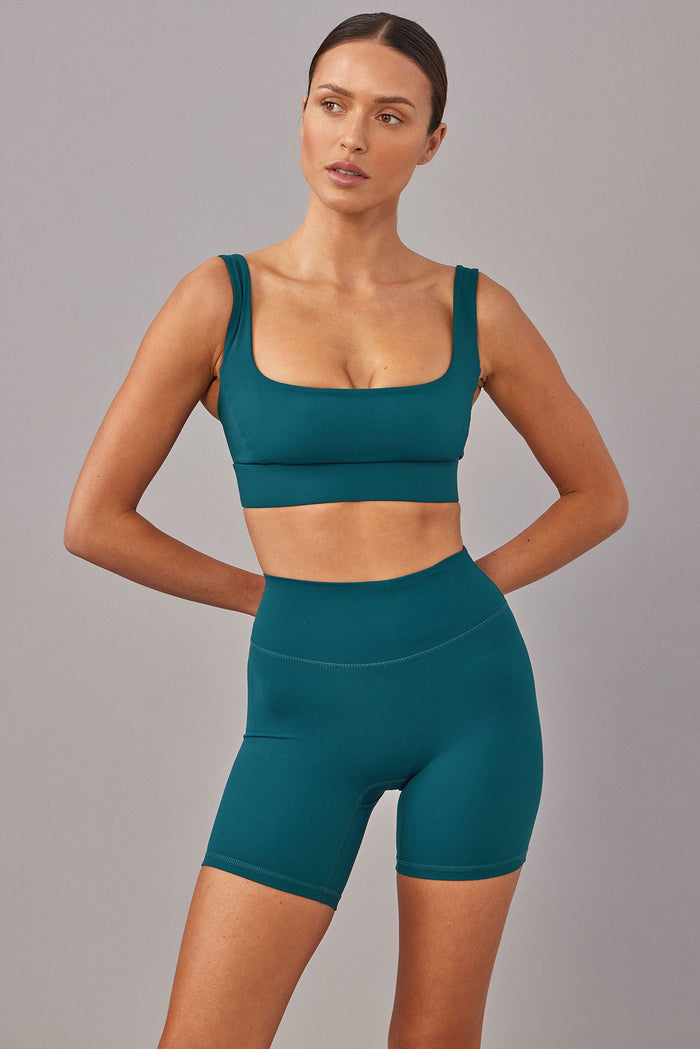 Front view of Griffith Short 6.25-inch in Evergreen showcasing high-waist fit and mid-thigh length on gray background