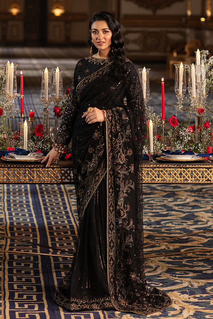 Naqshi Hainoor black net saree with Indian raw‑silk blouse richly adorned in hand‑adda—kora, dabka, threadwork, sequins—and crystal hangings on end, styled with raw‑silk petticoat.