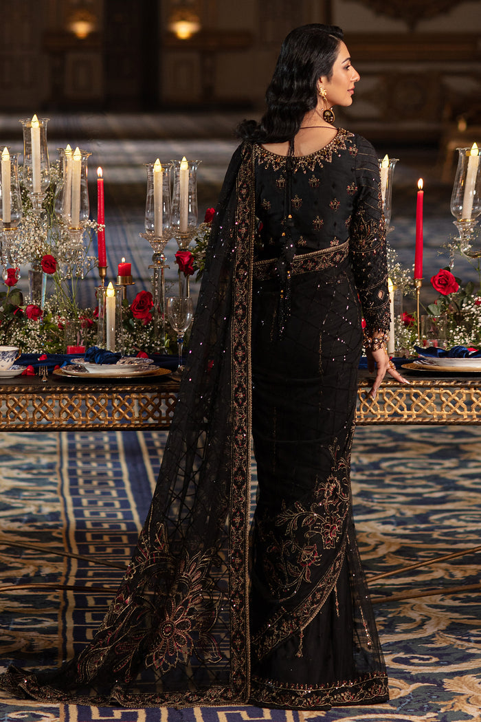 Side view of Naqshi Hainoor blouse showing cutwork sleeve detail, dangling bead embellishments and full thread-sequin embroidery on black canvas.