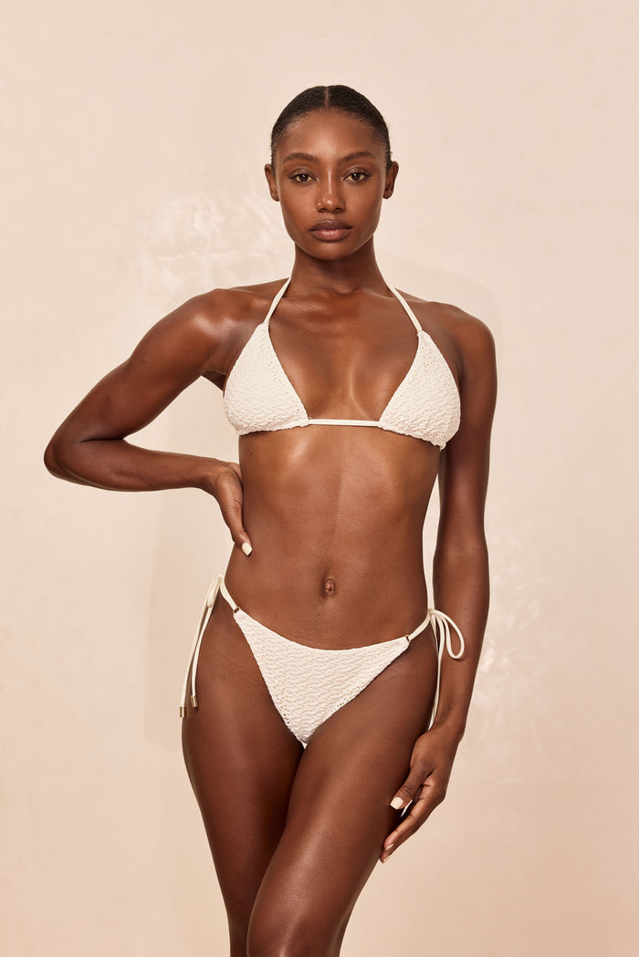 Front view of Hanalei Top in ivory crochet showcasing triangle cups and adjustable neck and back ties on beige background
