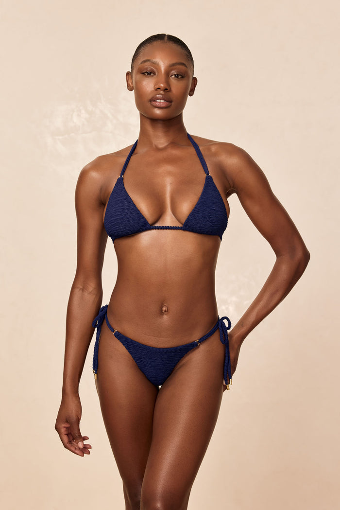 Front view of Hanalei Top in Midnight Crinkle showing triangle cups, adjustable halter ties and crinkle texture on a beige studio background