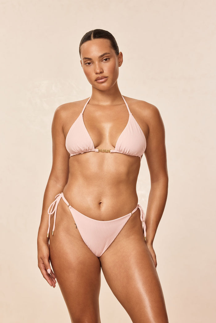 Front view of Hanalei bottom in powder pink rib with ribbed texture and tie-side detail on model against neutral background