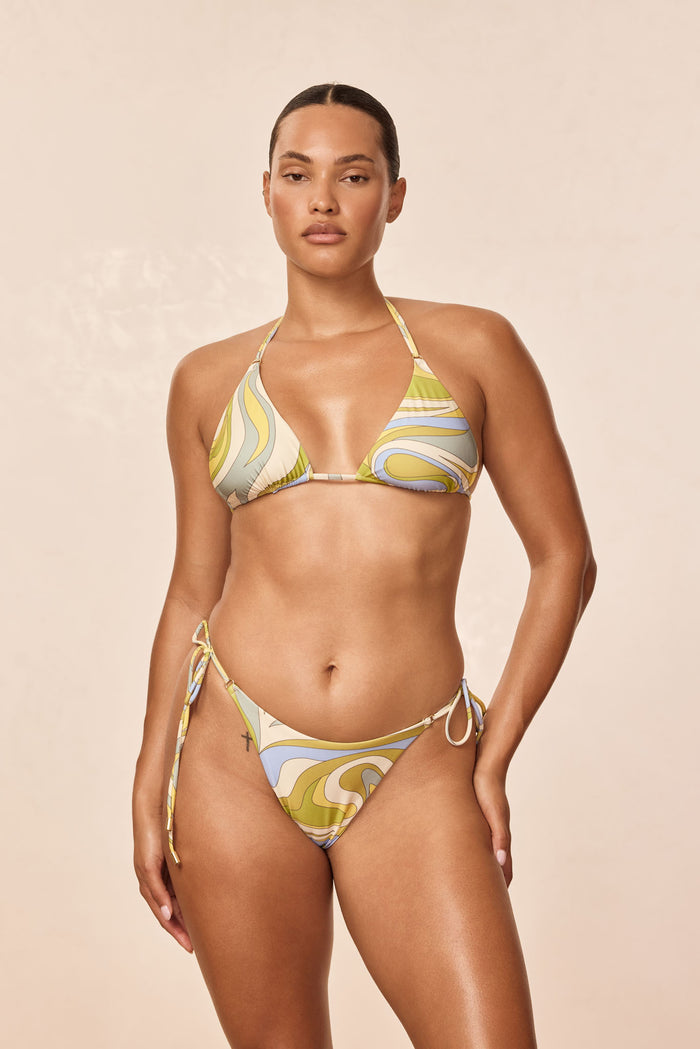 Front view of Hanalei triangle bikini top in Costa Rei Apple print with ruched cups and halter ties on a model