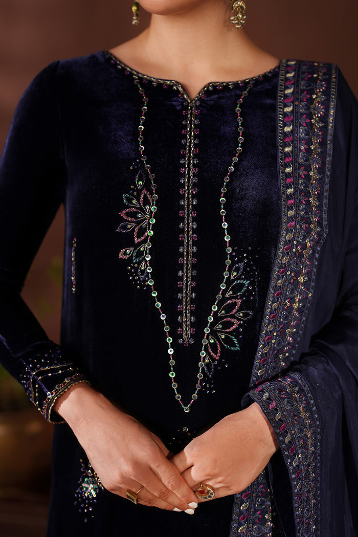 Close-up view of NAQSHI navy blue formal dress showing embroidery on neckline and front detailing