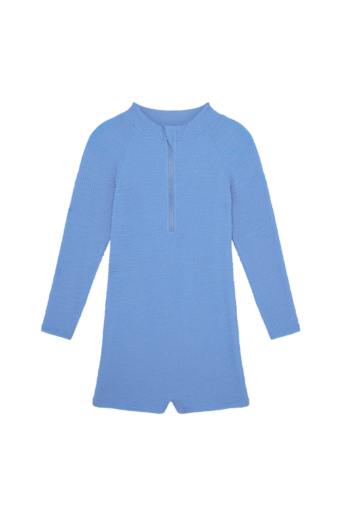 Front view of Hilo One Piece in Azure Crinkle showcasing textured crinkle fabric, center-front zip, long sleeves, and short legs on white background