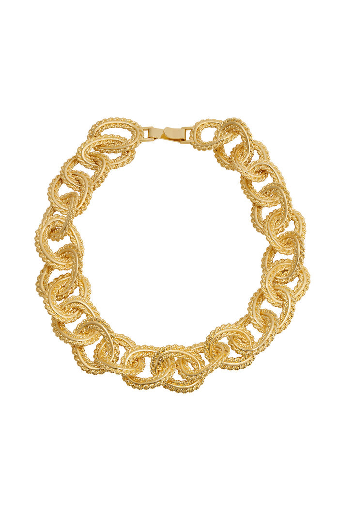 Close-up of Holbox necklace in gold showing twisted rope textured interlocking round links and box clasp on white background